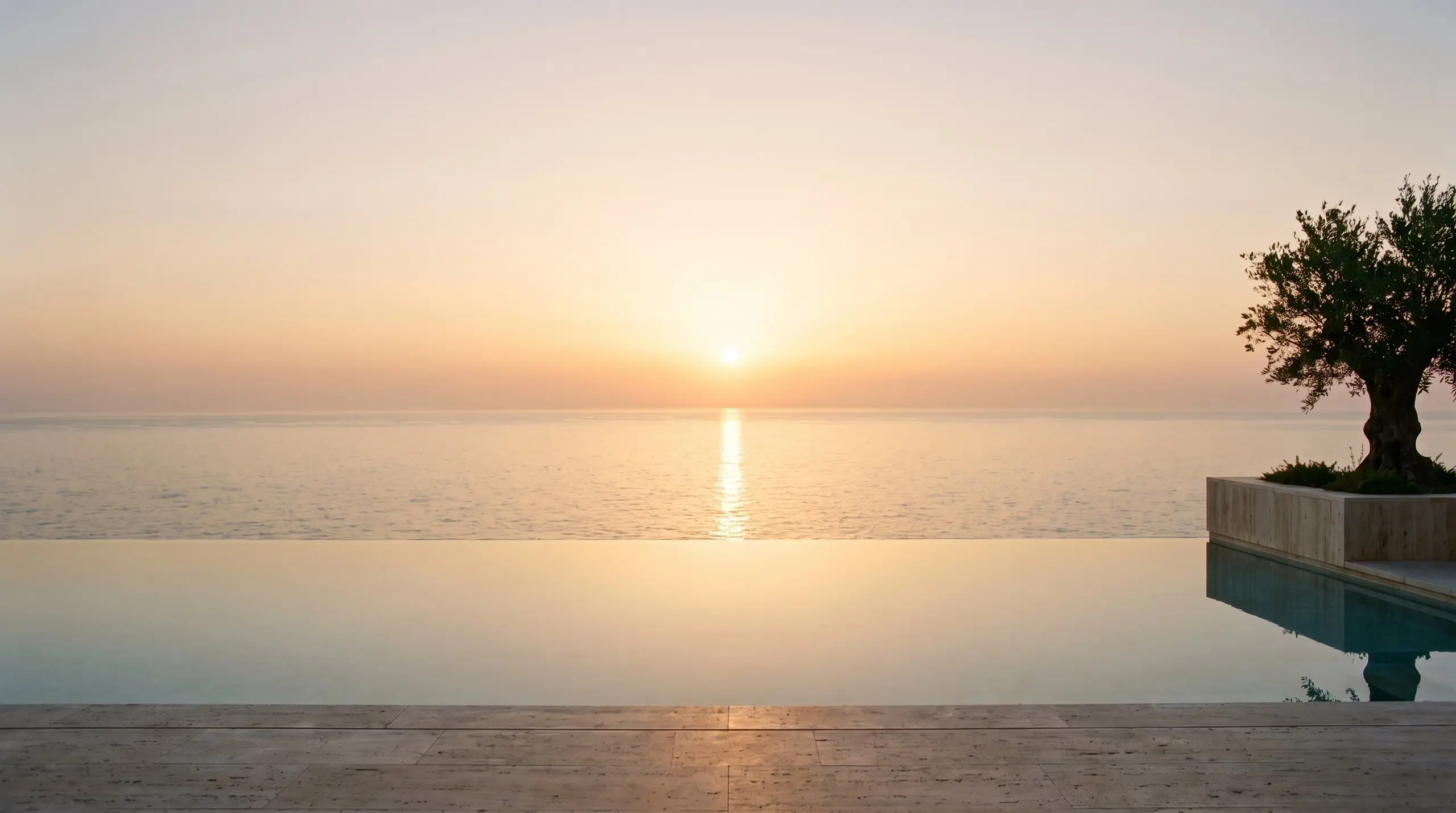 The sun rises over the Atlantic and lays a golden path to the pool